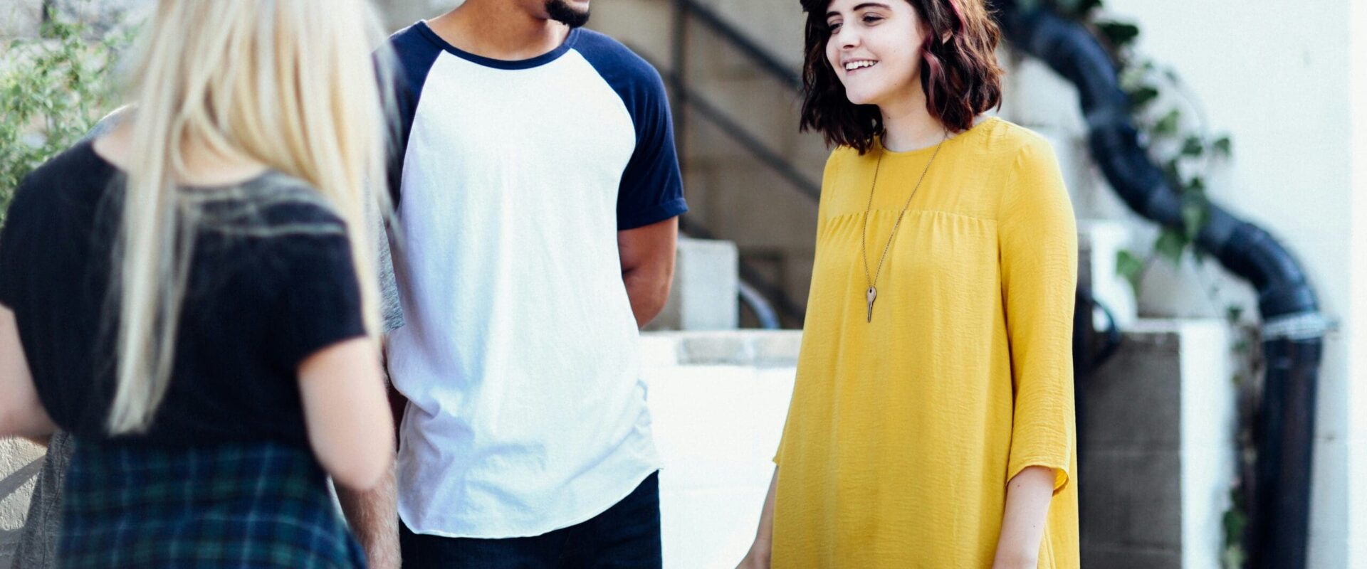 Three young people speaking outdoors