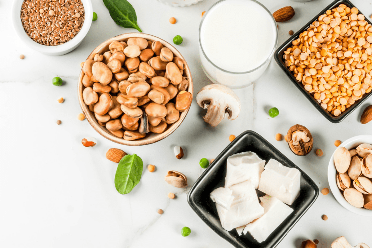 Various protein-rich plant-based foods on a white table.