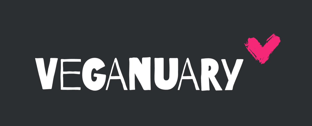 Veganuary logo with bold white text on a dark gray background and a pink brushstroke heart graphic next to the text.